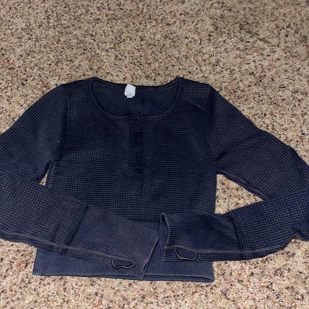 Never worn, tight , and has thumb holes